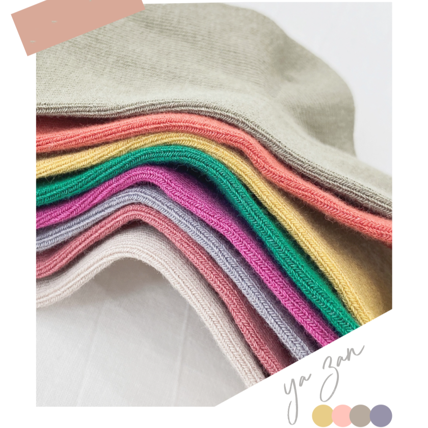 Stack of colourful fabric swatches with